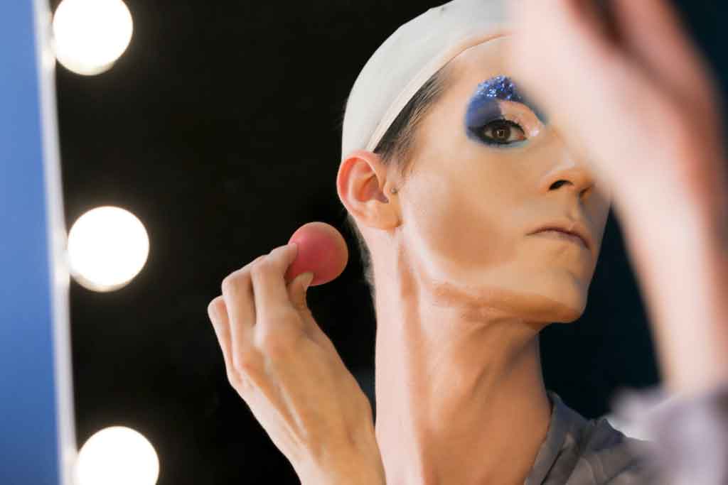 Drag queen applying makeup