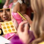 Drag performer applying makeup
