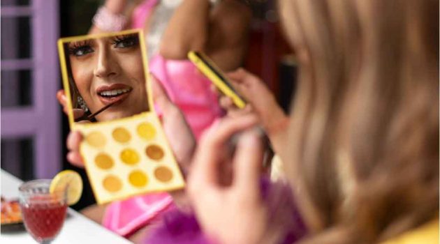 Drag performer applying makeup