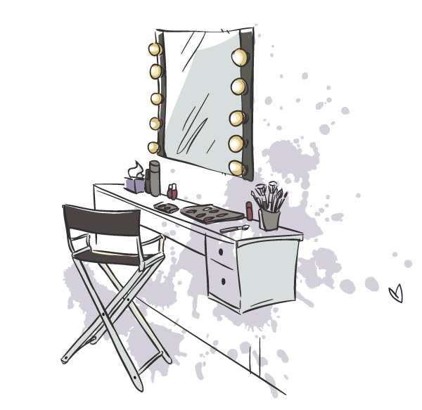 A well-organized drag transformation workspace with mirrors, makeup, and a comfortable chair
