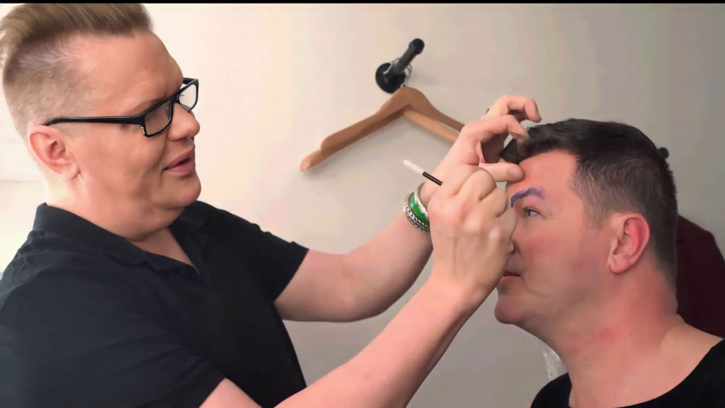 Jeff Roose applying makeup on a client