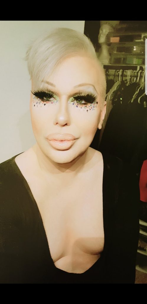 Jenni P, radiating confidence and beauty in captivating drag attire.