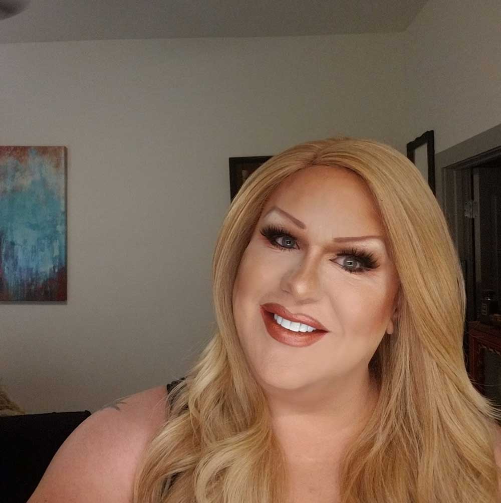 Jenni P, the drag persona of Jeff Roose, showcasing a stunning transformation.